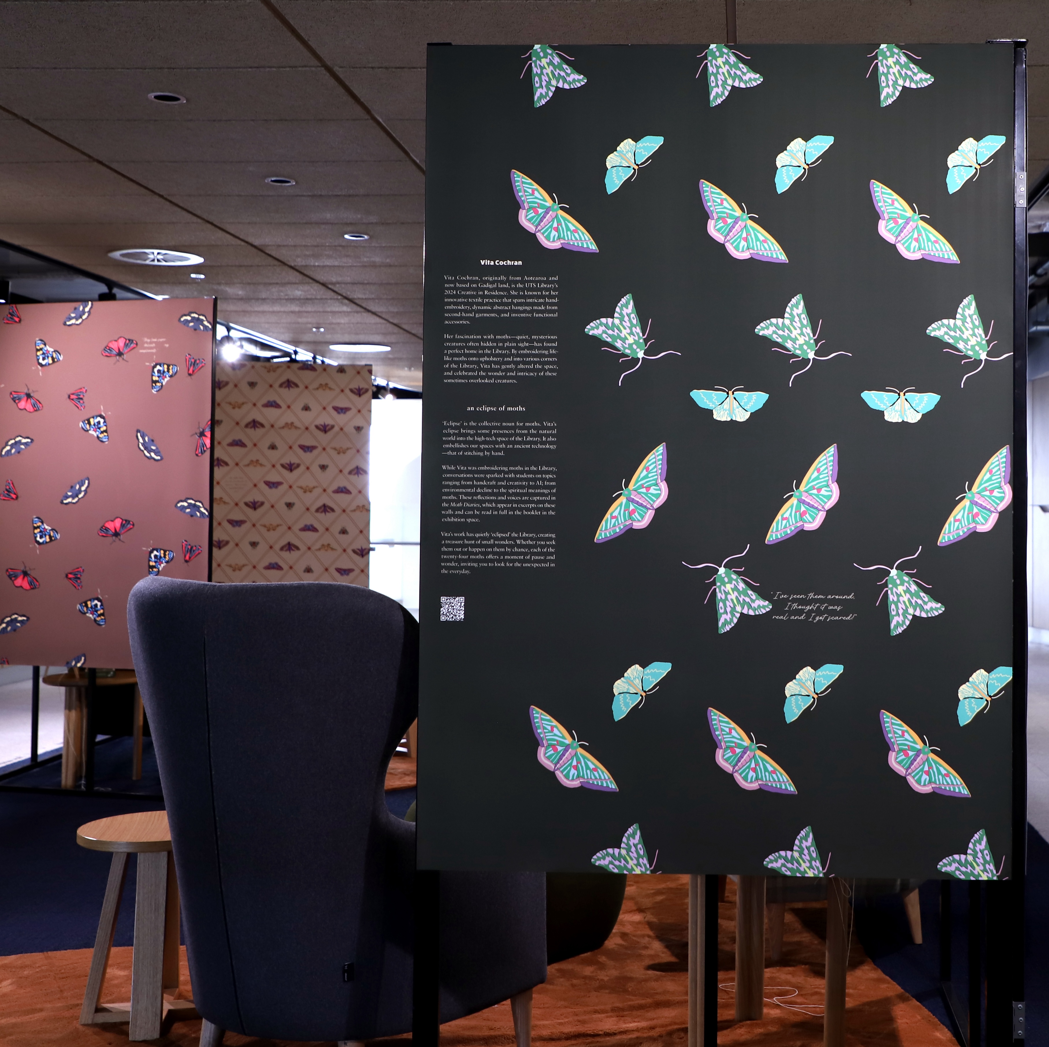 Exhibition screen with illustrative moths