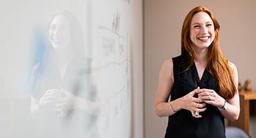 Teacher smiling at whiteboard