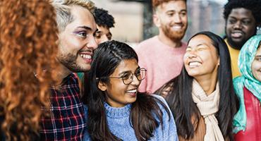 Group of students smiling at each other