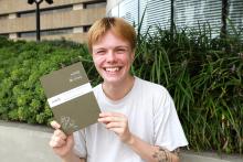 Excited student holding notebook